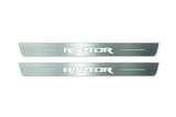 Two long silver-finished door sill plates with Raptor lettering on a light background, straight-on view.
