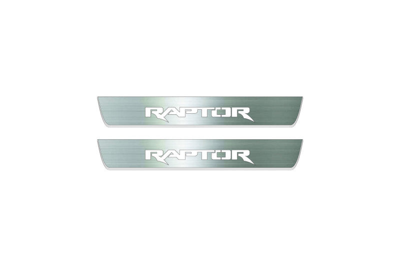 Two short silver-finished door sill plates with Raptor lettering on a light background, straight-on view.