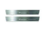 Two long silver-finished door sill plates with R Design lettering on a light background, straight-on view.
