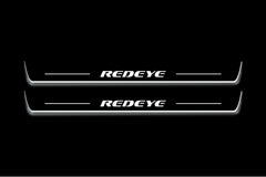 Two long door sill plates with Redeye lettering and edges illuminated in white, straight-on view on a dark background.
