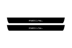 Catalog illustration of two black front door sill plates with Regal lettering.