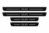 Catalogue illustration of two long front and two shorter rear black Matte PRO plates with illuminated CLIO lettering and horizontal top lines; side edges are unlit. FRONT option contains only front pair; final Clio IV dimensions are vehicle-specific.