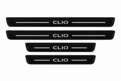 Catalogue illustration of two long front and two shorter rear black Matte PRO plates with illuminated CLIO lettering and horizontal top lines; side edges are unlit. FRONT option contains only front pair; final Clio IV dimensions are vehicle-specific.