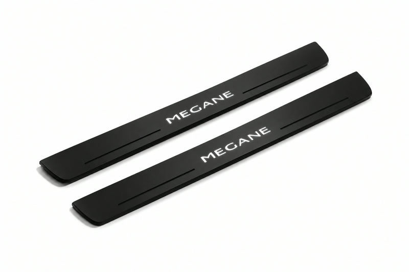 Catalogue illustration of two front black Matte PRO LED door sill plates with illuminated Megane lettering for Renault Megane II; dimensions are selected during manufacture.