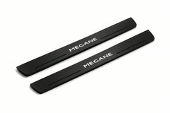 Catalogue illustration of two front black Matte PRO LED door sill plates with illuminated Megane lettering for Renault Megane III; dimensions are selected during manufacture.