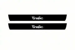 Catalogue illustration of two front black Matte PRO LED door sill plates with illuminated Trafic lettering for Renault Trafic Van X83; dimensions are selected during manufacture.