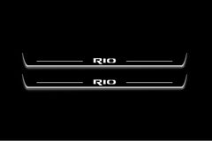 Two long door sill plates with Rio lettering and edges illuminated in white, straight-on view on a dark background.