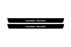 Catalog illustration of two black front door sill plates with Range Rover lettering.