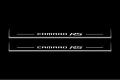Two long door sill plates with Camaro RS lettering and edges illuminated in white, straight-on view on a dark background.