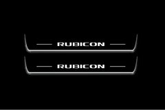 Two long door sill plates with Rubicon lettering and edges illuminated in white, straight-on view on a dark background.