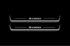 Two long door sill plates with S-Cross lettering and edges illuminated in white, straight-on view on a dark background.