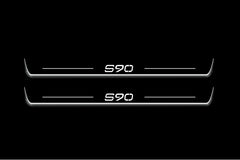 Two long door sill plates with S90 lettering and edges illuminated in white, straight-on view on a dark background.