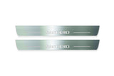 Two long silver-finished door sill plates with Sandero lettering on a light background, straight-on view.