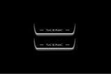 Two short door sill plates with Scenic lettering and edges illuminated in white, straight-on view on a dark background.