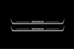 Two long door sill plates with Signum lettering and edges illuminated in white, straight-on view on a dark background.