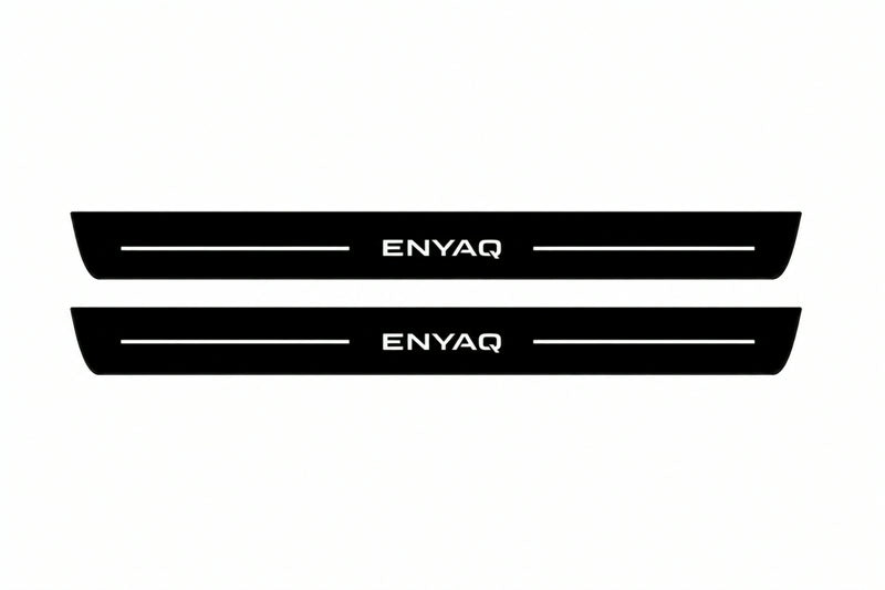 Catalogue illustration of two front black Matte PRO LED door sill plates with illuminated Enyaq lettering for Škoda Enyaq; dimensions are selected during manufacture.