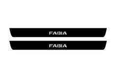 Catalog illustration of two black front door sill plates with Fabia lettering.