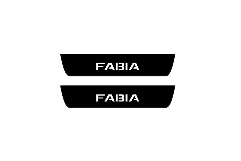 Catalog illustration of two black rear door sill plates with Fabia lettering.