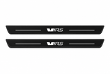 Catalogue demonstration of two black Matte PRO front plates with stylized VRS lettering and straight lines for Škoda Octavia Combi A7; dark side edges are unlit. FRONT+REAR adds two rear plates not pictured; dimensions are selected during manufacture.