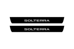 Catalog illustration of two black front door sill plates with Solterra lettering.