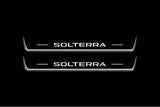 Two long door sill plates with Solterra lettering and edges illuminated in white, straight-on view on a dark background.