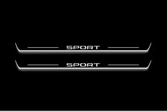 Two long door sill plates with Sport lettering and edges illuminated in white, straight-on view on a dark background.