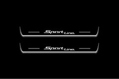 Two long door sill plates with Sport Line lettering and edges illuminated in white, straight-on view on a dark background.