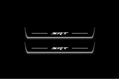 Two long door sill plates with SRT lettering and edges illuminated in white, straight-on view on a dark background.