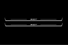 Two long door sill plates with SRT lettering and edges illuminated in white, straight-on view on a dark background.