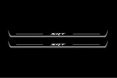 Two long door sill plates with SRT lettering and edges illuminated in white, straight-on view on a dark background.