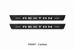 SsangYong Rexton Y400 Matte PRO catalogue illustration: two black FRONT plates with illuminated REXTON lettering on white