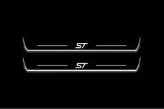 Two long door sill plates with ST lettering and edges illuminated in white, straight-on view on a dark background.
