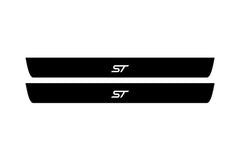 Catalog illustration of two black front door sill plates with ST lettering.