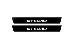 Catalog illustration of two black front door sill plates with Stelvio lettering.