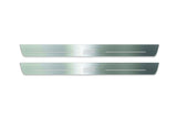 Two long silver-finished door sill plates with STI lettering on a light background, straight-on view.