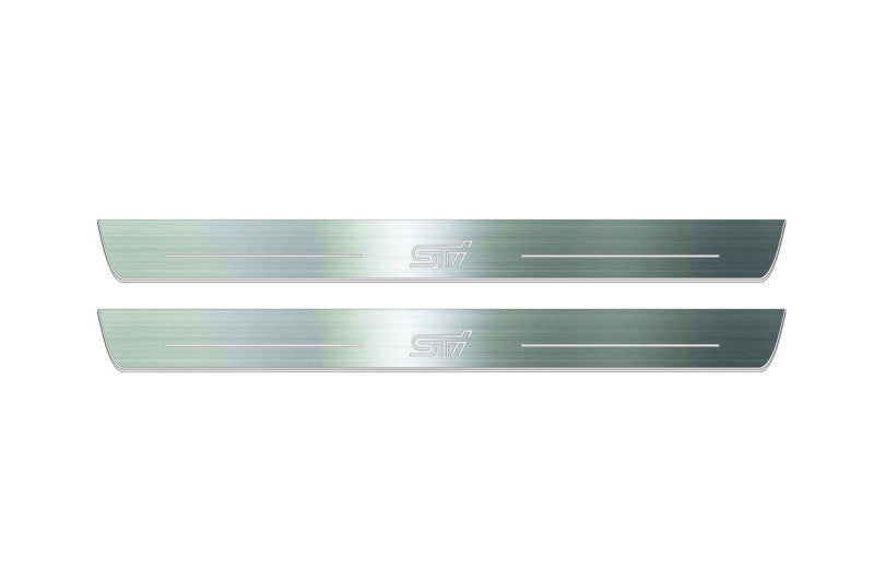 Two long silver-finished door sill plates with STI lettering on a light background, straight-on view.