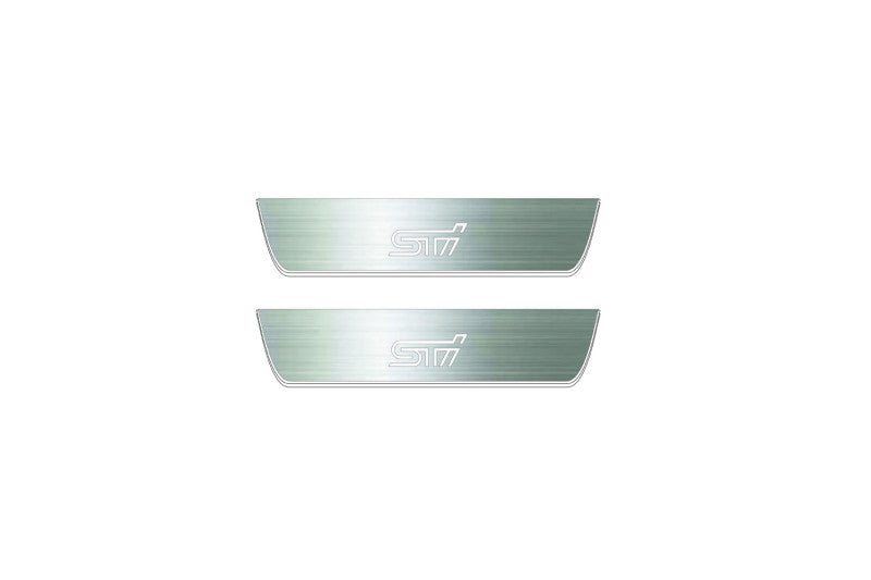 Two short silver-finished door sill plates with STI lettering on a light background, straight-on view.