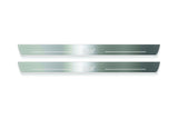 Two long silver-finished door sill plates with STI lettering on a light background, straight-on view.
