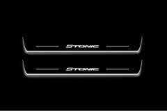 Two long door sill plates with Stonic lettering and edges illuminated in white, straight-on view on a dark background.
