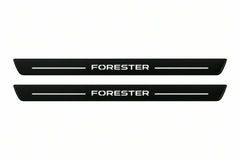 Catalogue illustration of two front black Matte PRO LED door sill plates with illuminated Forester lettering for Subaru Forester SK; dimensions are selected during manufacture.