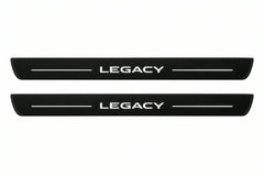 Catalogue illustration of two front black Matte PRO LED door sill plates with illuminated Legacy lettering for Subaru Legacy V; dimensions are selected during manufacture.