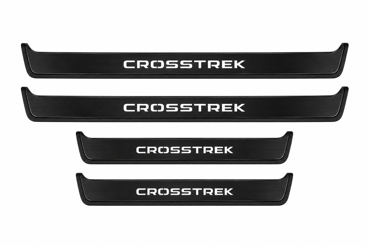 Catalogue illustration of two long black Matte PRO front sill plates and two shorter rear plates with CROSSTREK lettering illuminated on the top. Side edges unlit; vehicle-specific dimensions are not depicted. FRONT option includes front plates only.