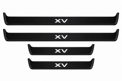 Catalogue illustration of two long black Matte PRO front sill plates and two shorter rear plates with XV lettering illuminated on the top. Side edges unlit; vehicle-specific dimensions are not depicted. FRONT option includes front plates only.