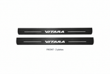 Suzuki Vitara Matte PRO catalogue illustration: two flat black FRONT plates with illuminated VITARA lettering on white background
