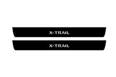Catalog illustration of two black front door sill plates with X-Trail lettering.