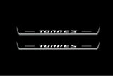 Two long door sill plates with Torres lettering and edges illuminated in white, straight-on view on a dark background.