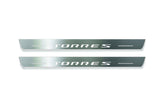 Two long silver-finished door sill plates with Torres lettering on a light background, straight-on view.