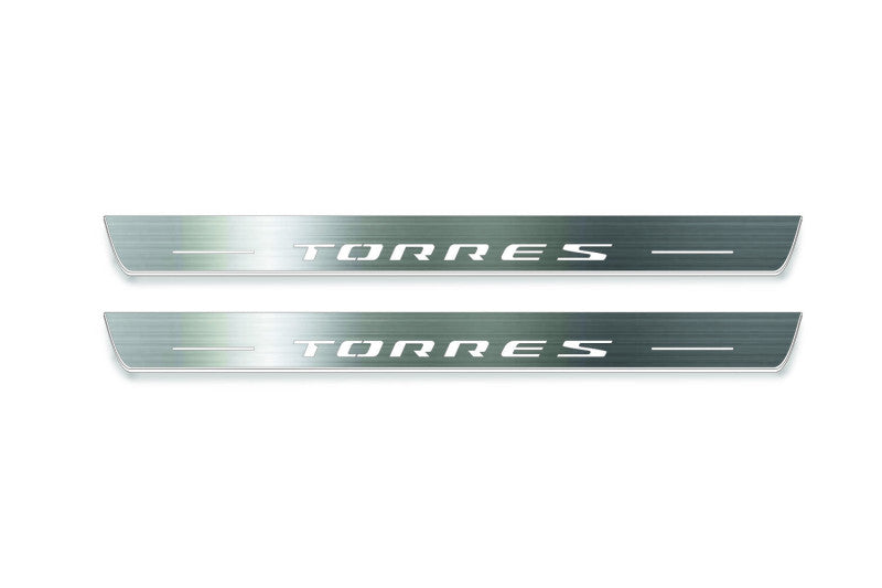 Two long silver-finished door sill plates with Torres lettering on a light background, straight-on view.