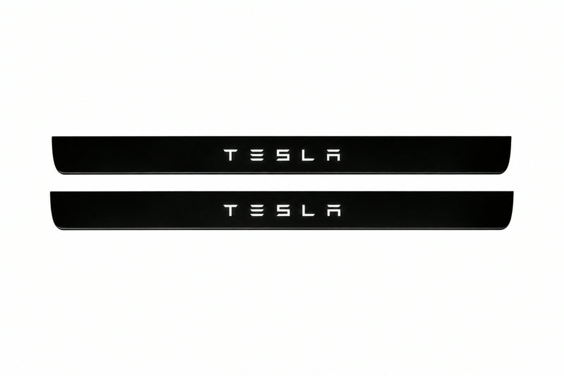 Catalogue illustration of two front black Matte PRO LED door sill plates with illuminated TESLA lettering for Tesla Model 3; dimensions are selected during manufacture.