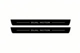 Catalogue illustration of two front black Matte PRO LED door sill plates with illuminated Dual Motor lettering for Tesla Model S; dimensions are selected during manufacture.